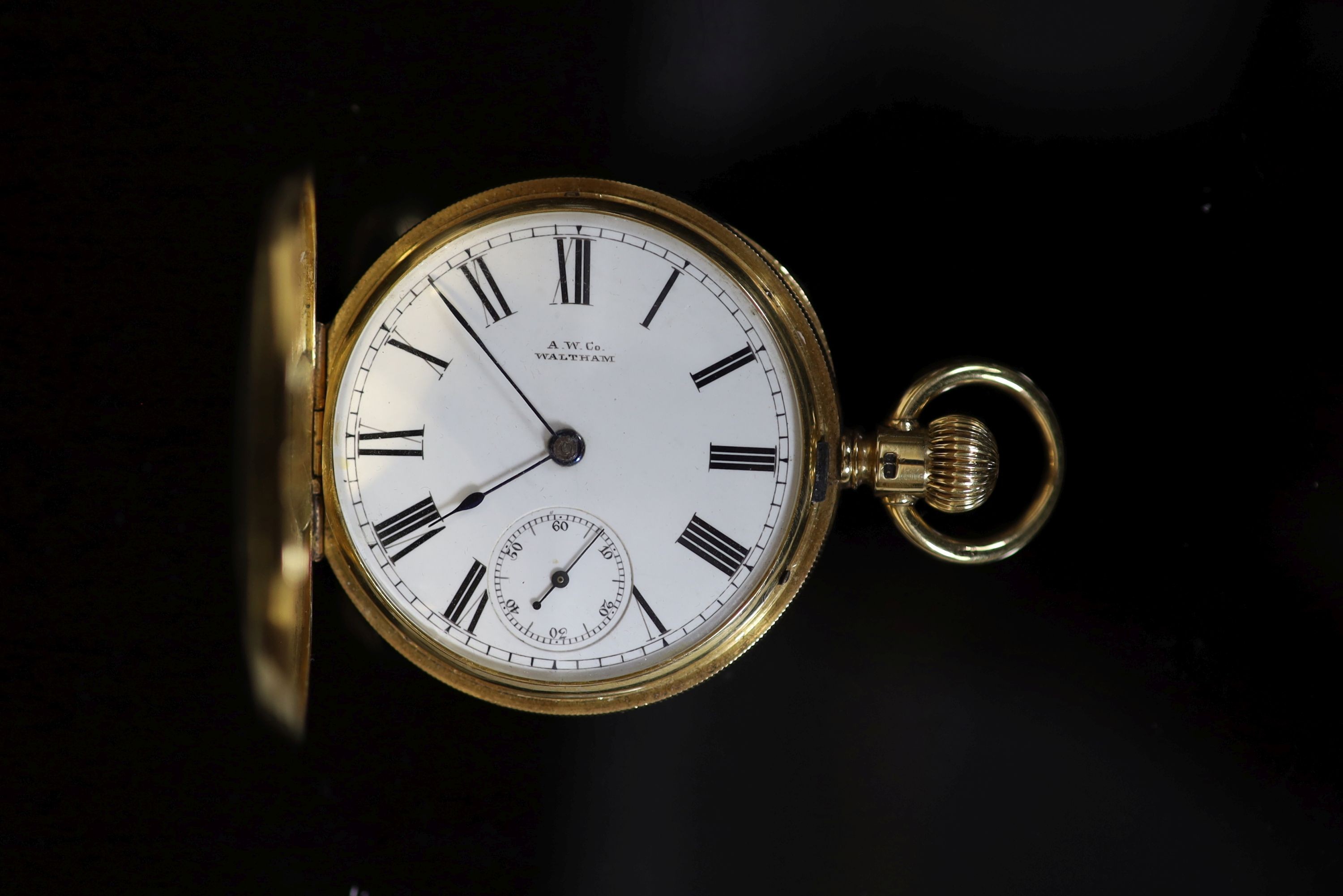 A late Victorian engine turned 18ct gold A W. Co Waltham hunter keyless lever pocket watch
